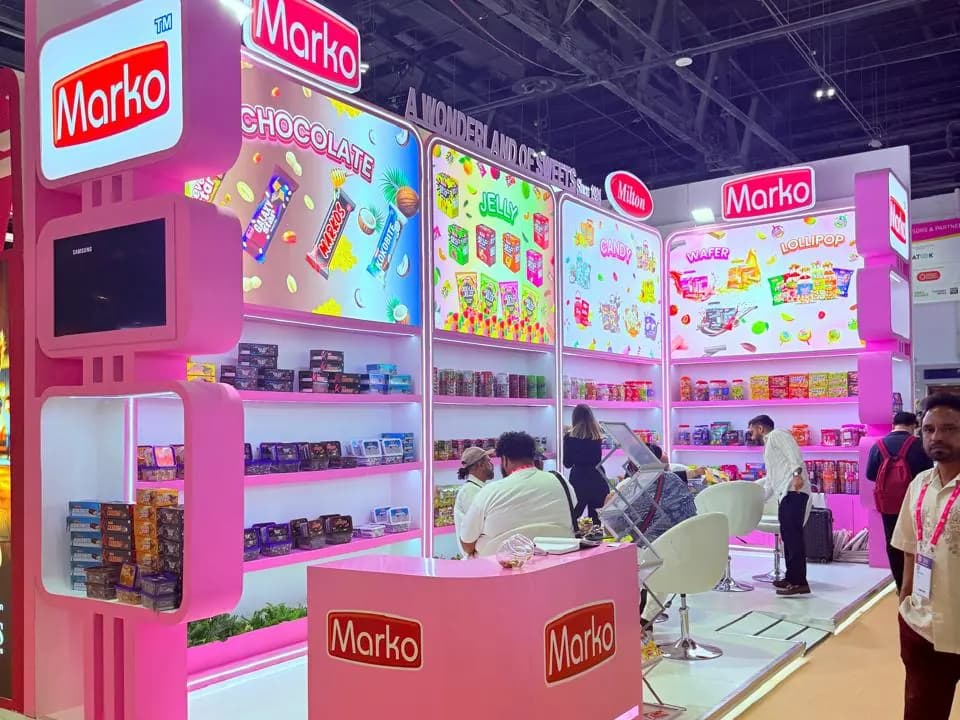 Marko pink confectionery stand with backlit chocolate and candy shelves at ISM Middle East 2025