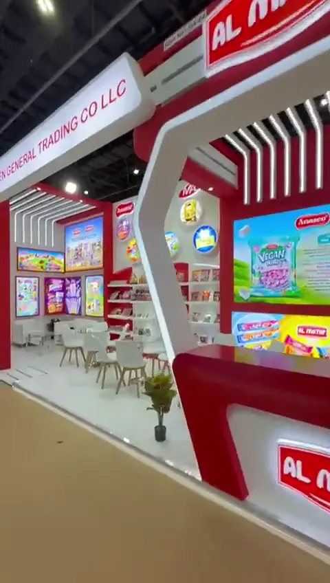 Confectionery stand with arched shelving and a lounge, built for ISM Middle East 2025 in Dubai.